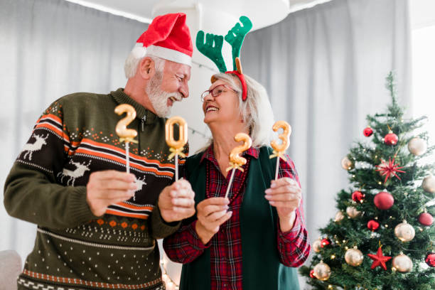 istock Senior couple holding numbers 2023 while celebrating New Year 1431943318