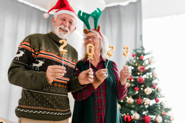 istock Senior couple holding numbers 2023 while celebrating New Year 1431943584