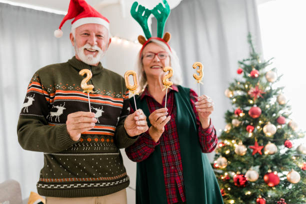 istock Senior couple holding numbers 2023 while celebrating New Year 1431945112