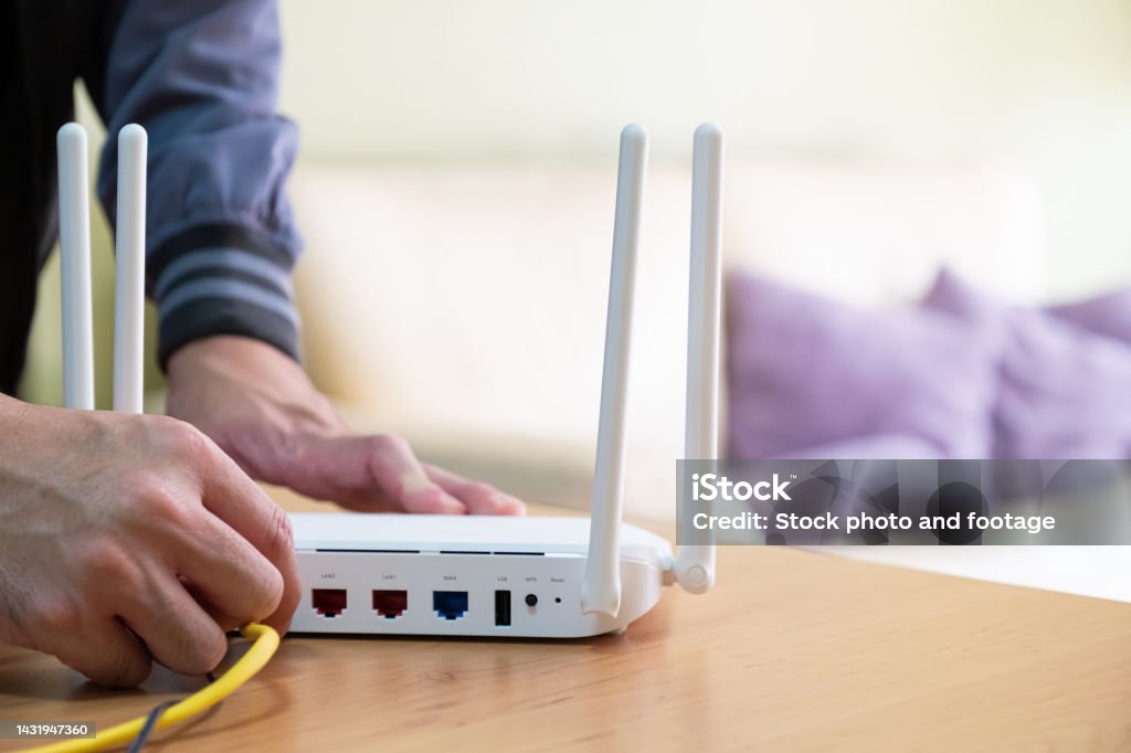 Guy Using A Router Selective Focus At Router Internet Router On Working Table While ...
