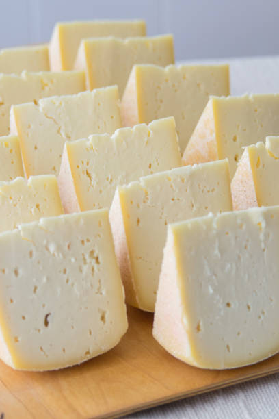 istock Cheese pieces on a wooden board, selective focus. Goat cheese, long ripening craft cheese. 1431948079