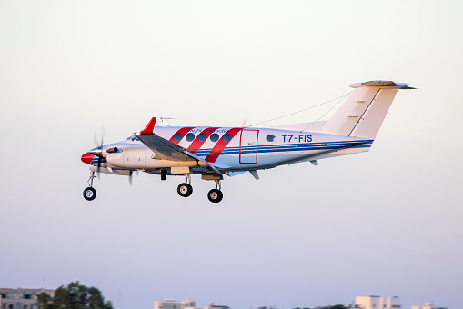 Luqa, Malta - October 4, 2022: ACAM Flight Calibration Services Aircraft: Beechcraft 200 Super King Air (REG: T7-FIS) landing in the sunset.