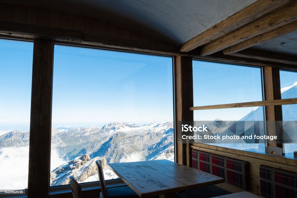 Indoor shot of the table decoration inside of the restaurant that have exotic scenery of Titlis ice mountain in Switzerland during summer season. Travel destination, no people. Beauty Stock Photo