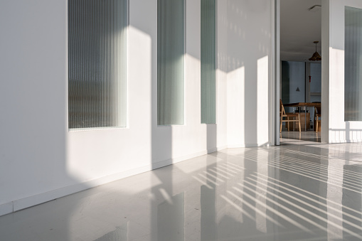 Shadows from the sunlight on the corridor, in the white room