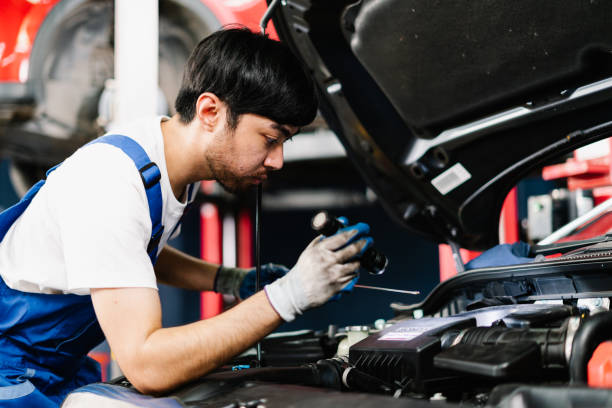 istock Auto mechanic is diagnosing the cause of an engine problem that needs to be fixed at the shop, Car Service Center and Automobile Maintenance 1431964542