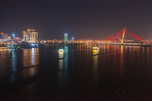 Drone view of Tran Thi Ly bridge in Da Nang city in sunset by Tra river, Da Nang city, Quang Nam Da Nang province