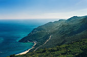 Portugal, Setubal, beach beautiful nature maintains and ocean. Long road between the mountains and coastline full of boats.