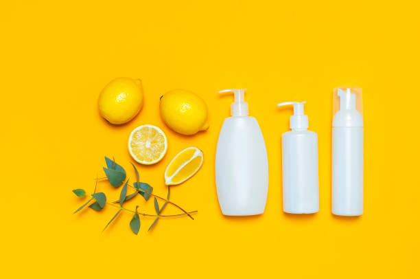 istock Whites Cosmetic bottle containers fresh lemon orange eucalyptus on yellow background top view flat lay copy space. Blank label for branding mock-up Natural beauty product concept Shower Gel Soap Cream 1431968706
