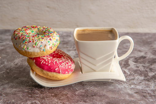 Cup of coffee with sweet donut