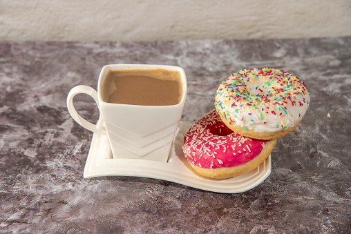 Cup of coffee with sweet donut