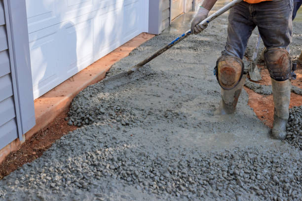 istock Construction contractors pouring wet concrete while paving a driveway as they work on a concrete construction project 1431969122