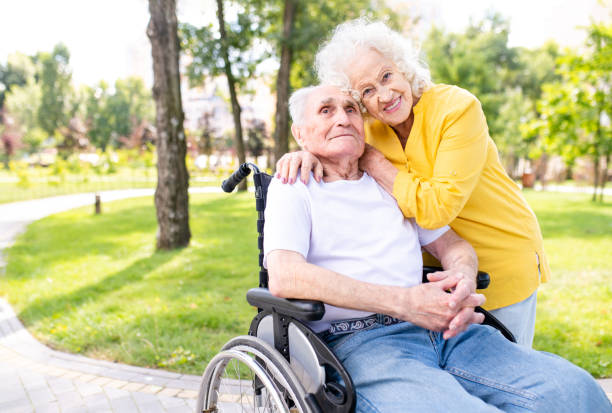 istock Senior couple with disability walking at the park 1431970730