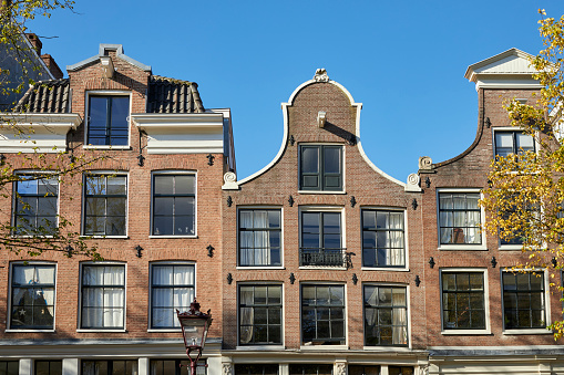 Narrow canal houses facade in Amsterdam, The Netherlands