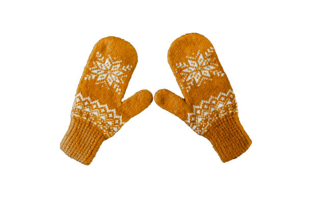 pair of yellow orangeknitted mittens with christmas pattern isolated on stock photo