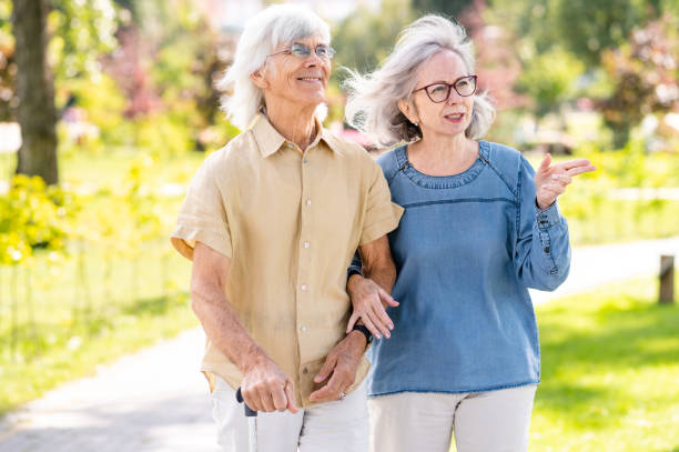 istock Senior couple with disability walking at the park 1431972537