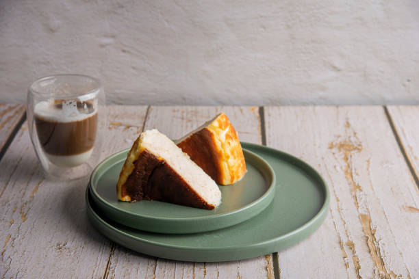 istock Sliced san sebastian cheesecake with coffee on wooden table 1431972545