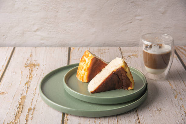 istock Sliced san sebastian cheesecake with coffee on wooden table 1431972548