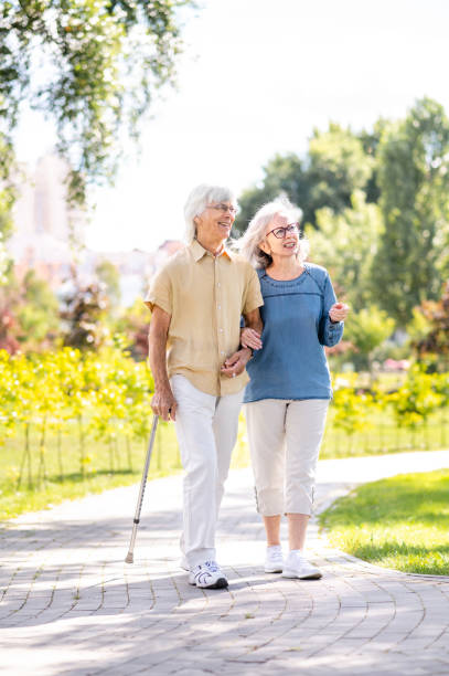 istock Senior couple with disability walking at the park 1431973151
