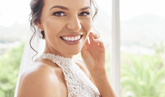 Beauty, smile and makeup with portrait of bride ready for wedding, celebration, event and party. Happy, cosmetics and young woman excited for marriage ceremony with luxury, fashion and jewellery