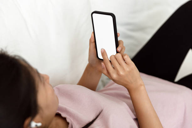 istock Woman relaxing on a sofa at home and using a smartphone 1431976235