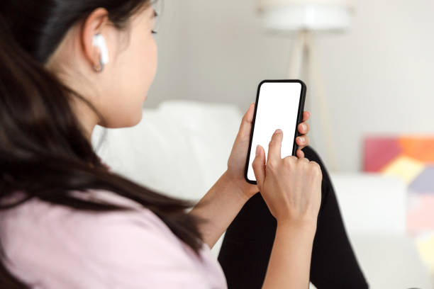 istock woman using smartphone at home, messaging or browsing social networks while relaxing on couch 1431976236