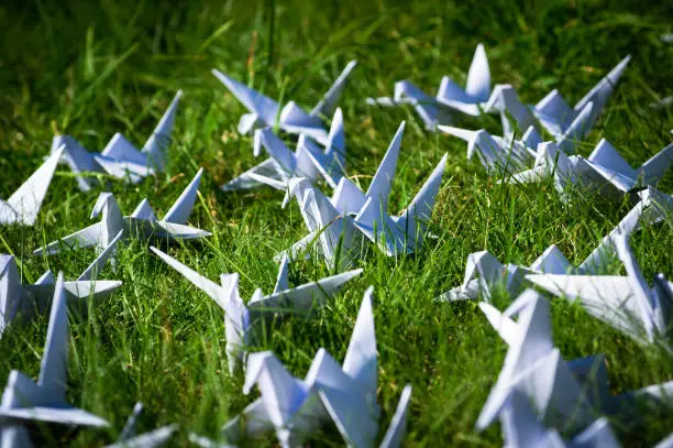 Photo of Japanese 1000 folded origami cranes on fresh grass
