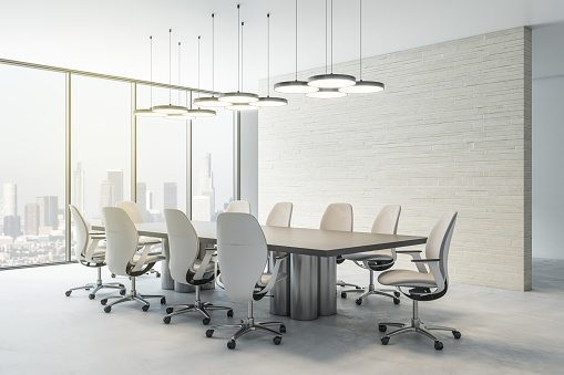 Sunny skyscrapers view from spacious modern interior design conference room with stylish meeting table and chairs, lights from top and beige stone wall. 3D rendering