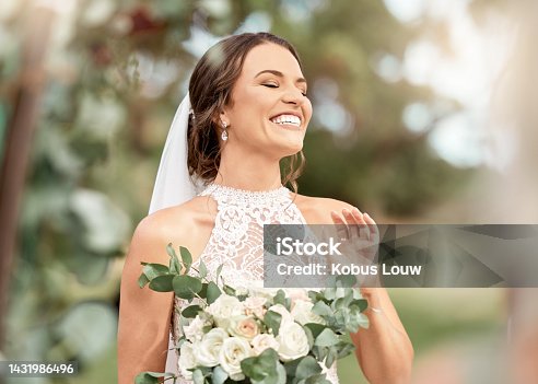 istock Excited bride in wedding with bouquet in nature park with green trees, bokeh and summer sunshine. Happiness, commitment and dream of a beauty woman with flowers for marriage in outdoor lens flare 1431986496
