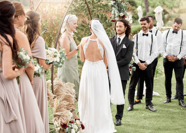 istock Wedding, speech and couple promise to love each other and commitment in marriage celebration ceremony event. Romance, save the date and young bride and groom holding hands make an oath outdoors 1431986568