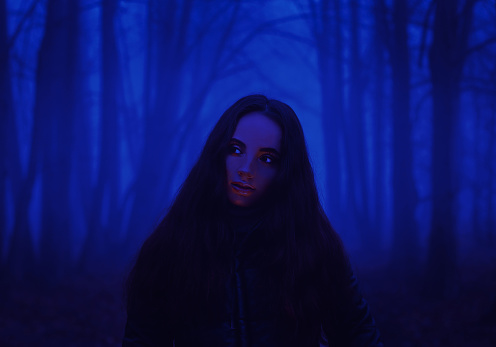 Gothic witch. Ghost in the fog. Girl in the paranormal world. Stranger forest in a fog. Mystical atmosphere. Dark wood. Mysterious road. Background wallpaper. Gloomy times. Dark background