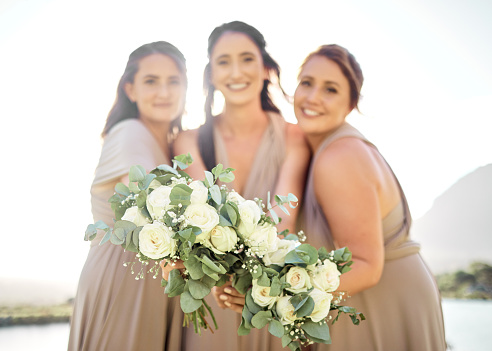 Wedding, flowers and happy bridesmaids with bouquet at party event for celebration, marriage and support. Creative, beauty and roses with women holding floral arrangement for wedding reception