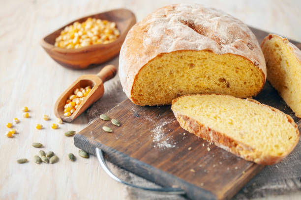 Fresh cornbread and corn grains on the table. Food grain crisis concept