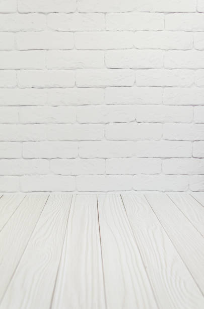 istock White brick wall, texture boards floor. Background, template, blank for advertising space for text. 1431988711