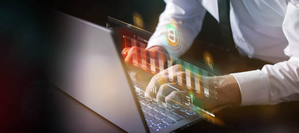 istock Businessman at laptop works with virtual data of Bitcoin falling. 1431988750
