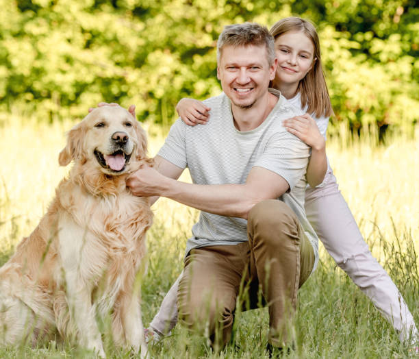 istock Dad and his daugter play with dog 1431989854