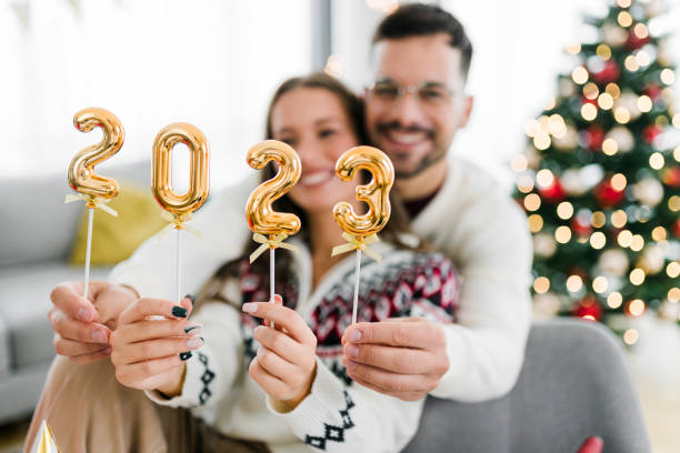 istock Couple holding numbers 2023 while celebrating New Year 1431990281