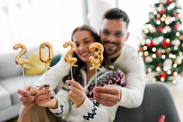 istock Couple holding numbers 2023 while celebrating New Year 1431990334