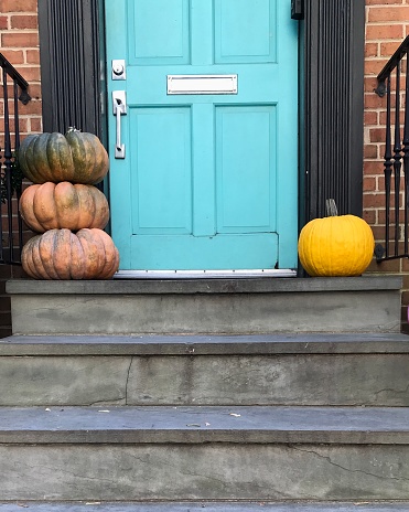Front entryway decorated with pumpkins