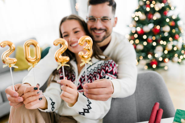 istock Couple holding numbers 2023 while celebrating New Year 1431990419