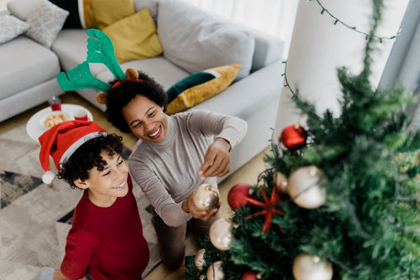 istock Boy decorating Christmas tree with his mother 1431991852