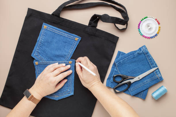 istock Old jeans and fabric bag with sewing accessories. Top view. Recycling concept. Crafting with denim. 1431992096