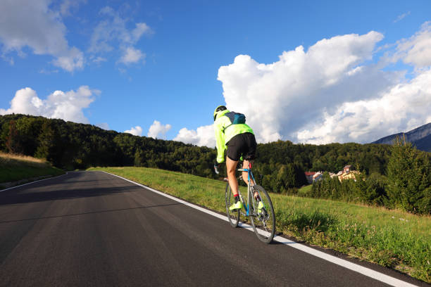 istock young cyclist with racing bicycle and phosphorescent waterproof jacket on the road 1431992176
