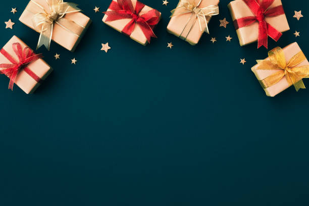 istock Frame from golden Christmas gift or present boxes and star confetti on blue background top view. Flat lay. 1431996943
