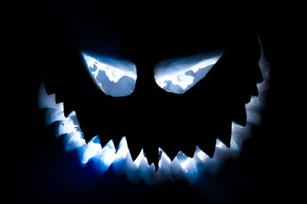 istock Halloween pumpkin glowing face in the dark. 1431999438