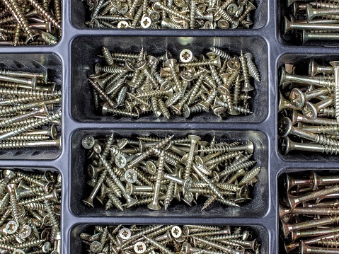 metal and wood screws in a plastic box