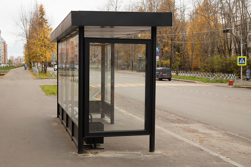 Bus stop in autumn city. Transport in an urban environment.