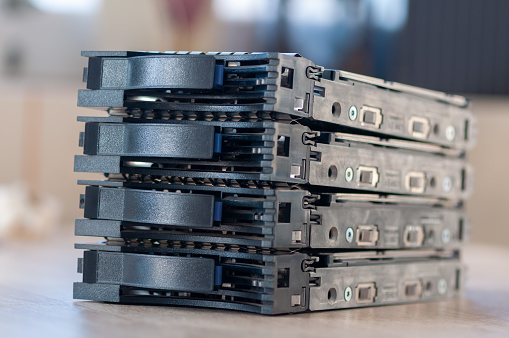 Close-up of a 2.5'' HDD server caddy tray stacked on each other on a table