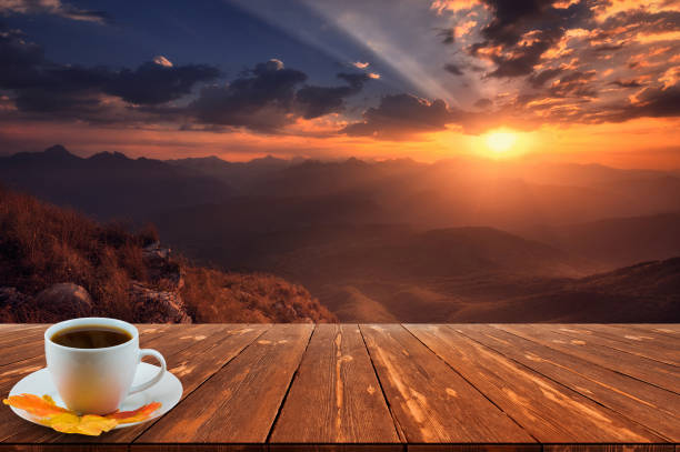 Coffee cup on wood table and view of beautiful nature background stock photo