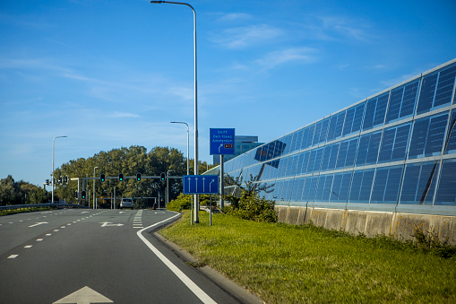 An outdoor solar panel site alongside a road in the Netherlands
