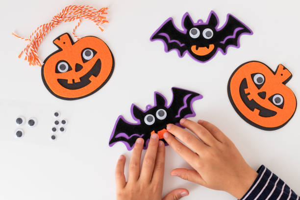 istock child making felt halloween decorations with spooky face 1432003723